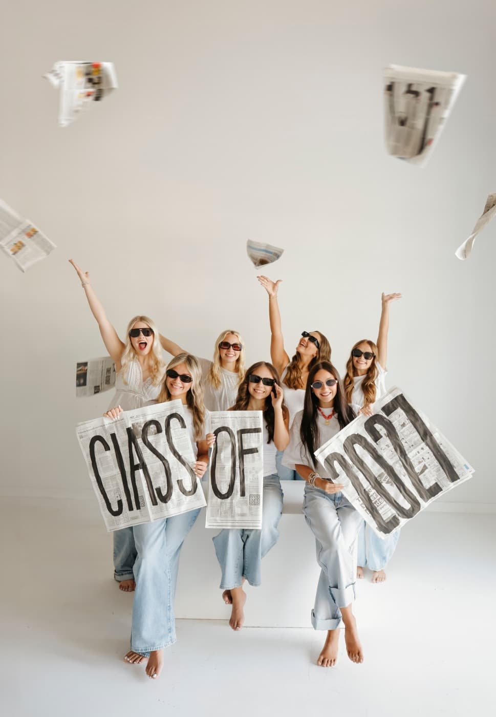 A group of seniors holding Class of 2027 newspaper signs